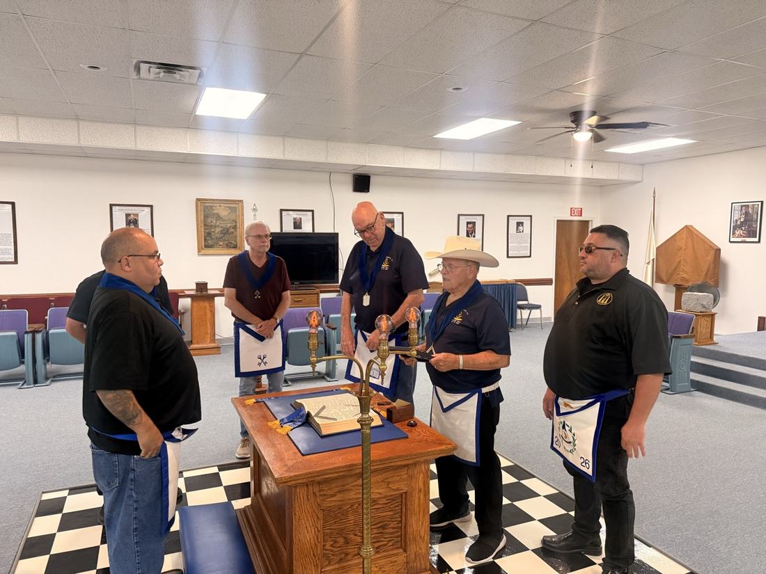 Five Brethren of Burkburnett Lodge No. 1027 standing around the altar as the Golden Trowel is presented, the Volume of the Sacred Law open before them